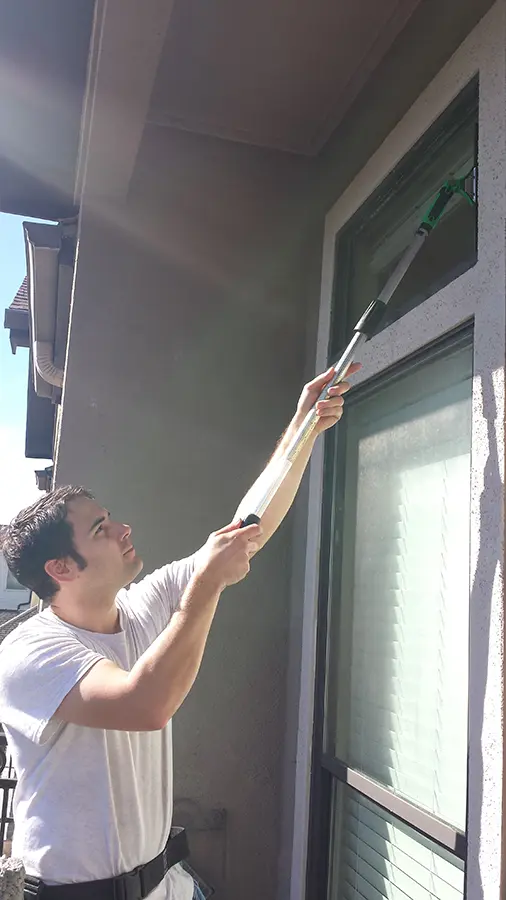Cory cleaning a window